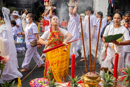 Ma-Song People with face pierced by steel skewers during at spirit ceremony and parade at Phuket Vegetarian Festival in Phuket City in Thailand. Thailand, Phuket, October 27, 2025のeditorial素材