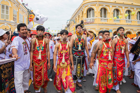 Ma-Song People with face pierced by steel skewers during at spirit ceremony and parade at Phuket...