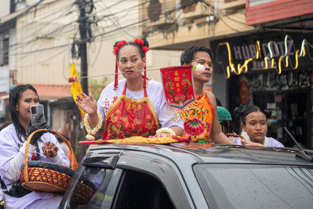Ma-Song People with face pierced by steel skewers during at spirit ceremony and parade at Phuket...