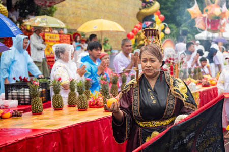 Ma-Song People with face pierced by steel skewers during at spirit ceremony and parade at Phuket...