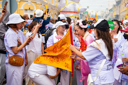 Ma-Song People with face pierced by steel skewers during at spirit ceremony and parade at Phuket...