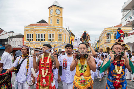 Ma-Song People with face pierced by steel skewers during at spirit ceremony and parade at Phuket...