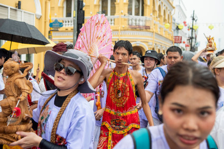 Ma-Song People with face pierced by steel skewers during at spirit ceremony and parade at Phuket...