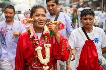 Ma-Song People with face pierced by steel skewers during at spirit ceremony and parade at Phuket Vegetarian Festival in Phuket City in Thailand. Thailand, Phuket, October 25, 2025のeditorial素材