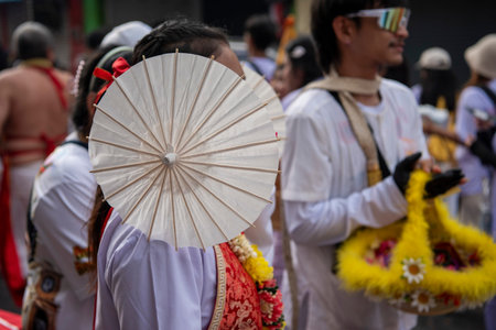 Ma-Song People with face pierced by steel skewers during at spirit ceremony and parade at Phuket...