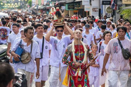 Ma-Song People with face pierced by steel skewers during at spirit ceremony and parade at Phuket Vegetarian Festival in Phuket City in Thailand. Thailand, Phuket, October, 26, 2025のeditorial素材