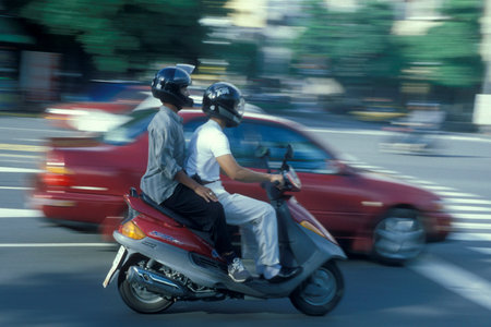 a motorbike on a road in the city center of Taipei in Taiwan of East Aasia. Taiwan, Taipei, May,...