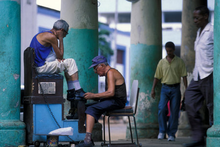 a shoemaker at a market in the city of Havana on Cuba in the Caribbean Sea. Cuba, Havana, October, 2005のeditorial素材