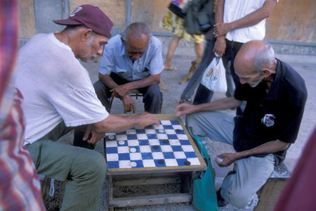 people play a board game in the city of Havana on Cuba in the Caribbean Sea. Cuba, Havana, October,...