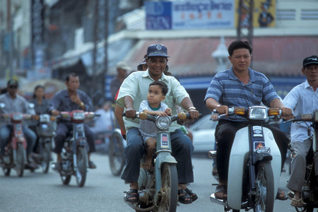 Motorbike on a road in the city of Phnom Penh of Cambodia.  Cambodia, Phnom Penh, February, 2001のeditorial素材