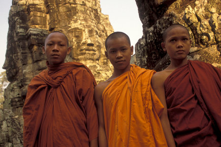 monks posing at the Bayon Temple the Tempel Ruins of Angkor Thom in the Temple City of Angkor near...