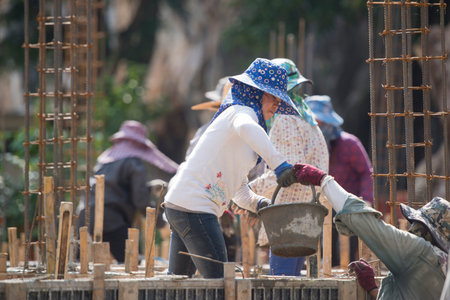women at a construction of a house near the city Chiang Rai in North Thailand.のeditorial素材