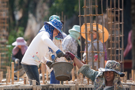 women at a construction of a house near the city Chiang Rai in North Thailand.のeditorial素材