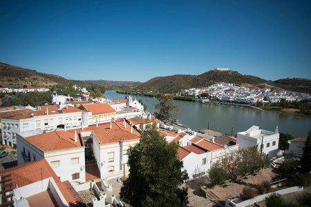 the town Alcoutim in Portugal and the town Sanlucar de Guadiana in Spain at the river Rio Guadiana on the Border of portugal and Spain at the east Algarve in the south of Portugal in Europe.のeditorial素材