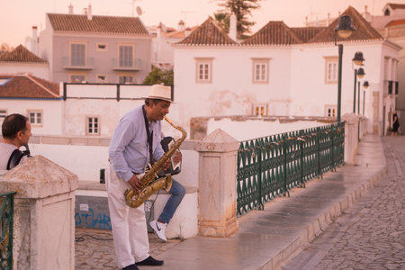 streetmusic on the Bridge Ponte Romana in the old town of Tavira at the east Algarve in the south of...
