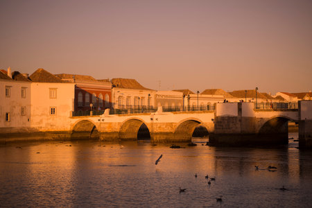 The Bridge Ponte Romana in the old town of Tavira at the east Algarve in the south of Portugal in...