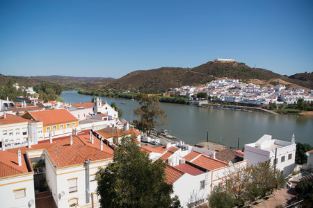 the town Alcoutim in Portugal and the town Sanlucar de Guadiana in Spain at the river Rio Guadiana on the Border of portugal and Spain at the east Algarve in the south of Portugal in Europe.のeditorial素材