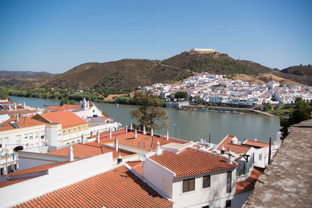 the town Alcoutim in Portugal and the town Sanlucar de Guadiana in Spain at the river Rio Guadiana on the Border of portugal and Spain at the east Algarve in the south of Portugal in Europe.のeditorial素材