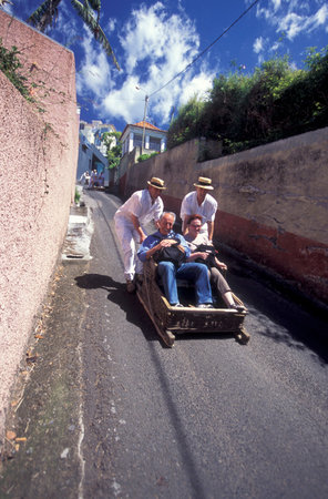 the traditional Basket Sledge Riding from Monte down to the old town of Funchal on the Island of Madeira in the Atlantic Ocean of Portugal.のeditorial素材