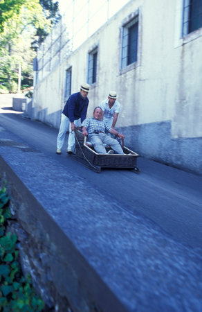 the traditional Basket Sledge Riding from Monte down to the old town of Funchal on the Island of Madeira in the Atlantic Ocean of Portugal.のeditorial素材