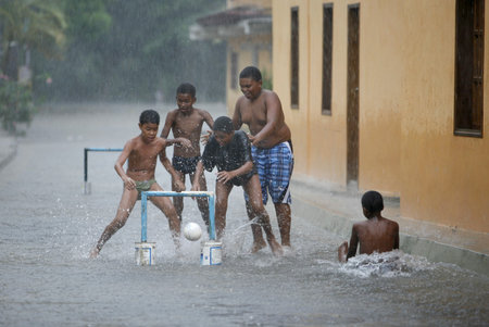 childern play soccer by rain in the town of chuao near choroni on the caribbean coast in Venezuela.のeditorial素材