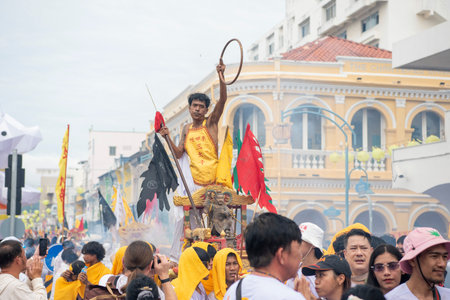 Devotees carry a litter housing a Taoist god idol during at spirit ceremony and Parade at Phuket...