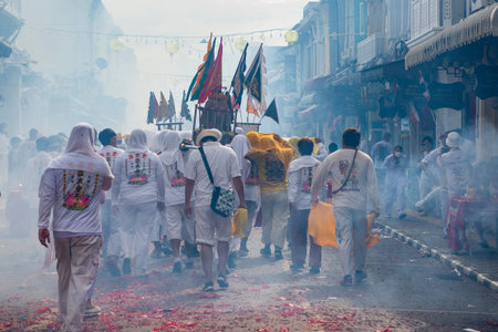 Devotees carry a litter housing a Taoist god idol during at spirit ceremony and Parade at Phuket...