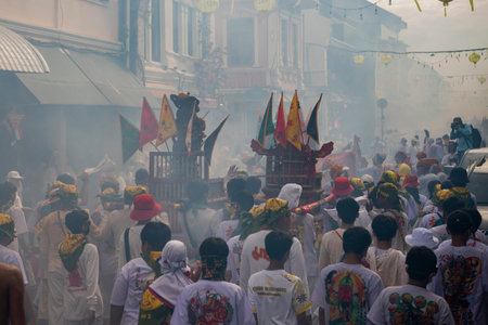 Devotees carry a litter housing a Taoist god idol during at spirit ceremony and Parade at Phuket...