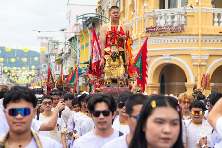 Devotees carry a litter housing a Taoist god idol during at spirit ceremony and Parade at Phuket...
