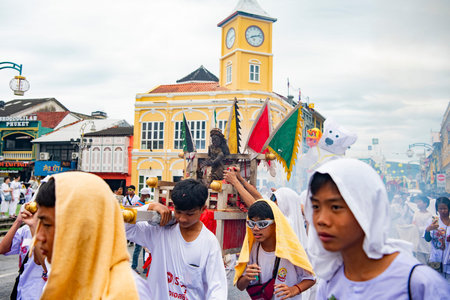 Devotees carry a litter housing a Taoist god idol during at spirit ceremony and Parade at Phuket...