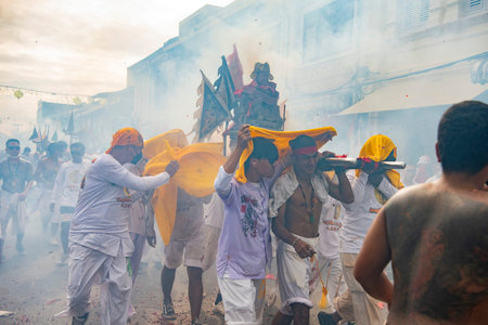 Firecrackers erupt around Devotees which carry a litter housing a Taoist god idol during a spirit Parade at Phuket City Vegetarian Festival in Thailand. Thailand, Phuket, October, 26, 2025のeditorial素材