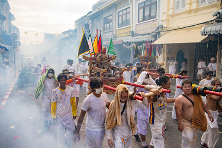 Firecrackers erupt around Devotees which carry a litter housing a Taoist god idol during a spirit...