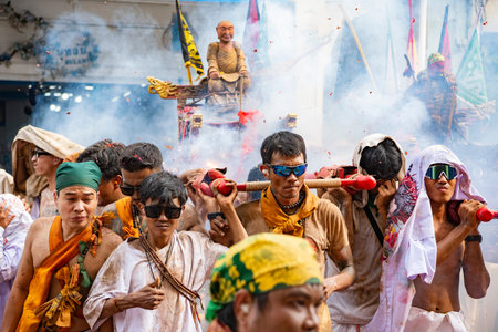 Firecrackers erupt around Devotees which carry a litter housing a Taoist god idol during a spirit...