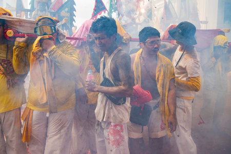 Devotees carry a litter housing a Taoist god idol during at spirit ceremony and Parade at Phuket...