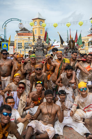 Devotees carry a litter housing a Taoist god idol during at spirit ceremony and Parade at Phuket...