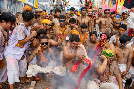 Firecrackers erupt around Devotees which carry a litter housing a Taoist god idol during a spirit...