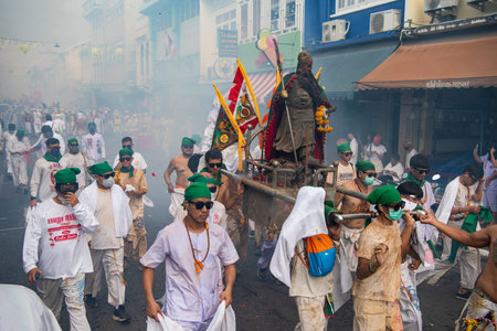 Devotees carry a litter housing a Taoist god idol during at spirit ceremony and Parade at Phuket...
