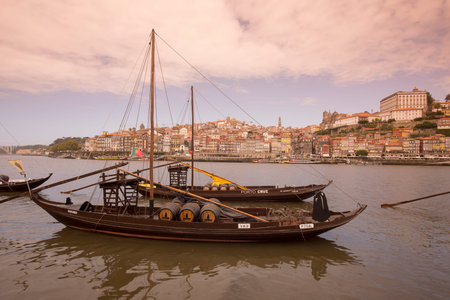 the port wine Boats at the waterfront with the old town on the Douro River in Ribeira in the city...