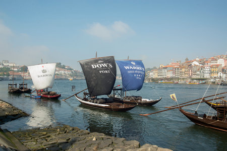 the port wine Boats at the waterfront with the old town on the Douro River in Ribeira in the city...