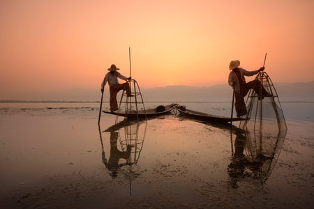 Fishermen at sunrise in the Landscape on the Inle Lake in the Shan State in the east of Myanmar in Southeastasia.のeditorial素材