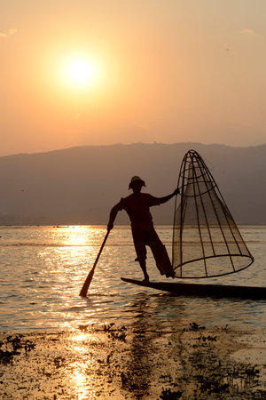 Fishermen at sunset in the Landscape on the Inle Lake in the Shan State in the east of Myanmar in Southeastasia.のeditorial素材
