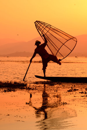 Fishermen at sunset in the Landscape on the Inle Lake in the Shan State in the east of Myanmar in Southeastasia.のeditorial素材