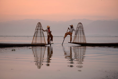 Fishermen at sunrise in the Landscape on the Inle Lake in the Shan State in the east of Myanmar in Southeastasia.のeditorial素材