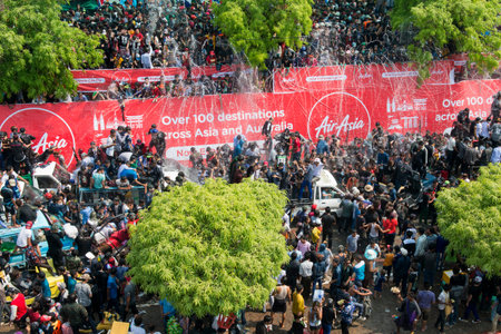 People at the Waterparty at the Thingyan Water Festival at the Myanmar New Year in the city centre...