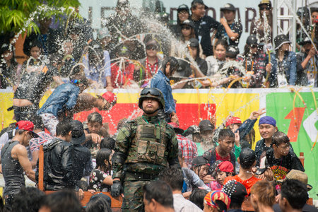 People at the Waterparty at the Thingyan Water Festival at the Myanmar New Year in the city centre of Mandalay in Manamar in Southeastasia.のeditorial素材