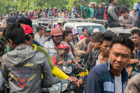 People at the Waterparty at the Thingyan Water Festival at the Myanmar New Year in the city centre of Mandalay in Manamar in Southeastasia.のeditorial素材
