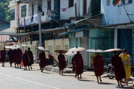 Monks on the road in the city centre of Myeik in the south in Myanmar in Southeastasia.のeditorial素材