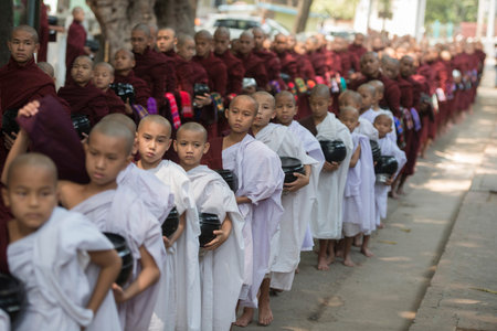 monks are on the way to the lunch at the Mahagandayon Monastery in Amarapura near the City of...