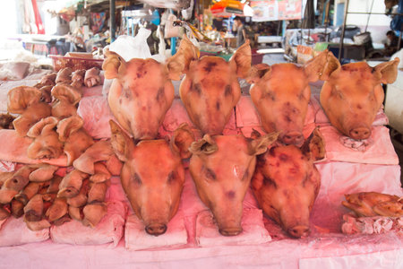 pork head meat at the market in the city centre of Udon Thani in the Isan in Northeast Thailand.のeditorial素材