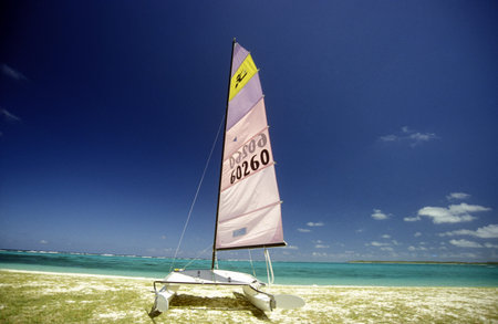 a sailboat on a beach on the island of Mauritius in the indian ocean